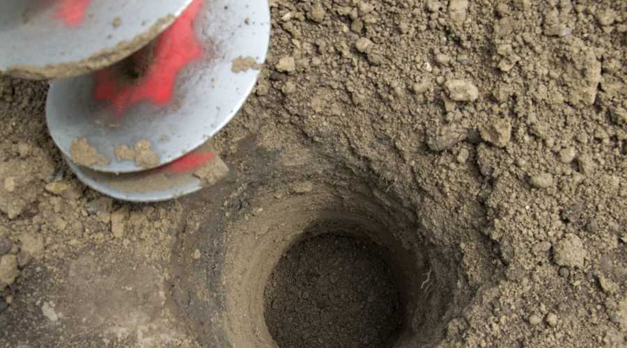 Post Hole Auger drilling into ground